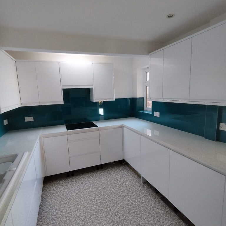 White and green kitchen Modern kitchen with white cabinets and turquoise tiled backsplash.