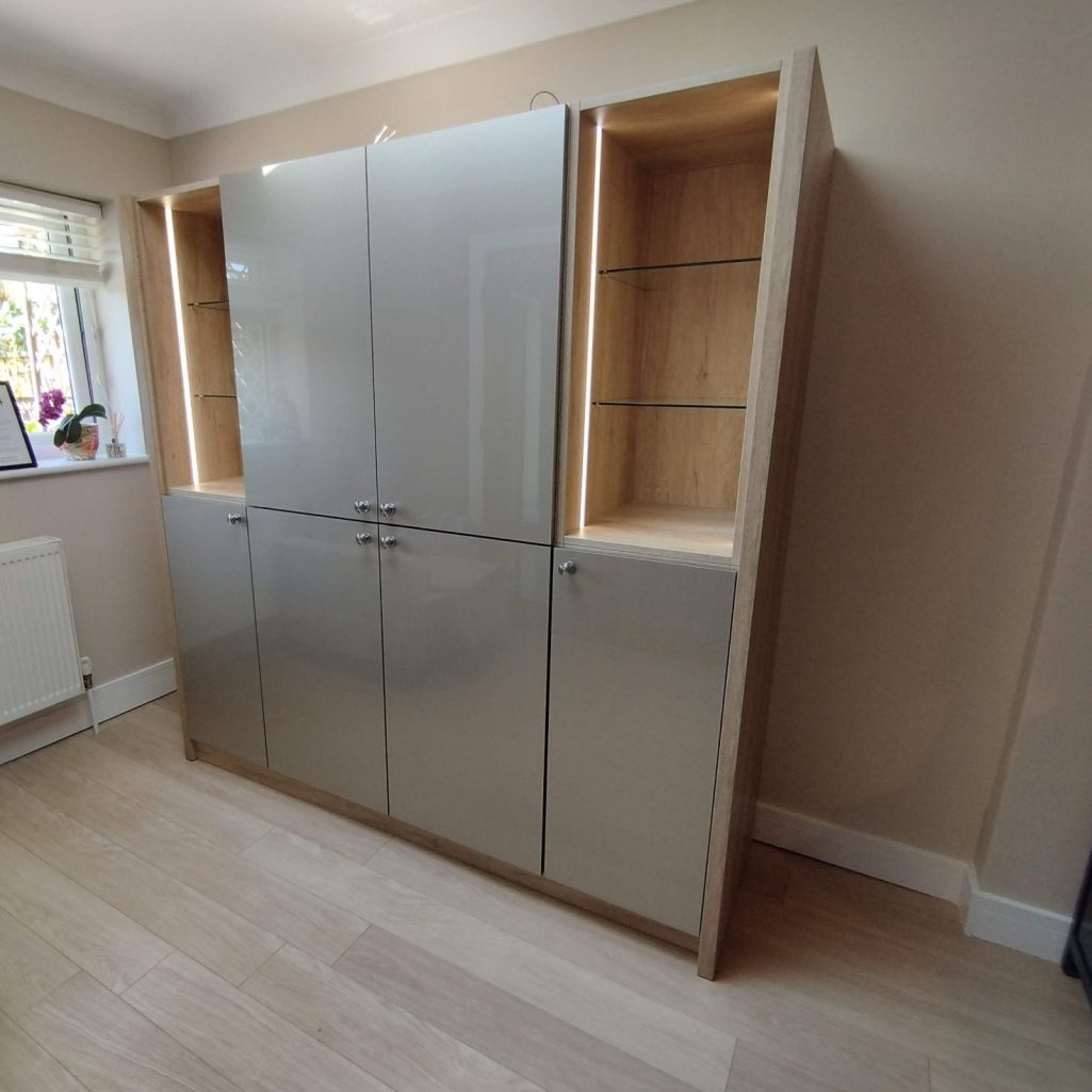 Bar cabinet Modern grey storage unit with wooden accents, featuring glass shelves and multiple cabinets.