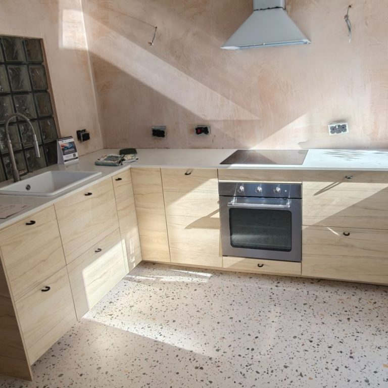 IKEA kitchen Modern kitchen with wooden cabinets, a sink, stove, and natural light.