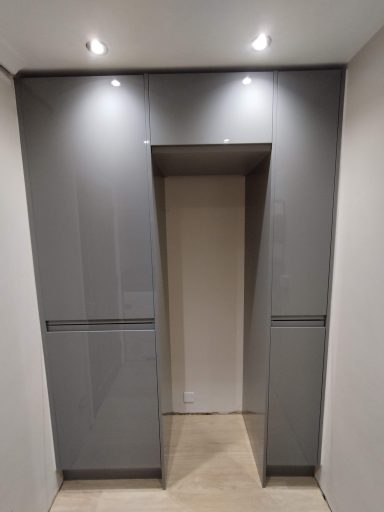 Contemporary grey entrance with recessed lighting and a minimalist design.