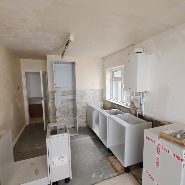 during installation A partially renovated kitchen with cabinets and plumbing fixtures installed.