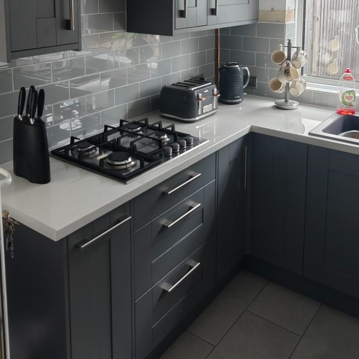 New Wickes kitchen Modern kitchen with grey cabinets, gas stove, and a window with natural light.