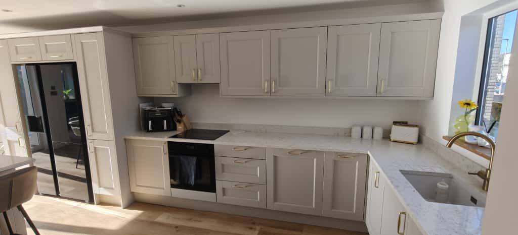 Bespoke kitchen Modern kitchen with light cabinetry, stainless steel appliances, and a spacious layout.