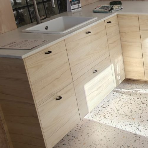 Ikea kitchen with sink Light wood kitchen cabinetry with a sink and countertop, featuring multiple drawers.